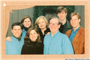 ["The 2000 Rockefeller family holiday card reads, \"Warmest wishes for a wonderful 1999 holiday season.\" Pictured are Jay, Sharon, Valerie, John, Emily, Justin, and Charles Rockefeller. On the back is an unofficial seal of the United States Senate."]%