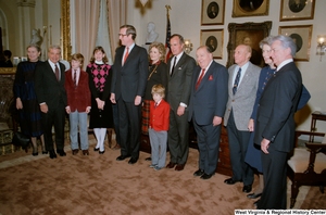 ["Family, fellow Senators, and Vice President George H. W. Bush surround Senator John D. (Jay) Rockefeller after the Senate swearing-in ceremony. (Wide angle photograph)"]%