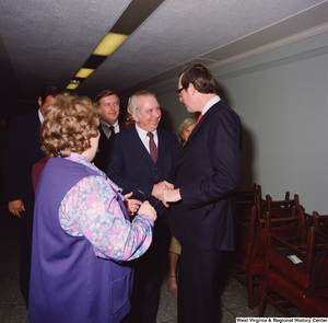 ["Senator John D. (Jay) Rockefeller is greeted by unidentified supporters following the Senate Swearing-In Ceremony."]%