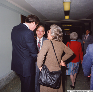 ["Senator John D. (Jay) Rockefeller speaks with two unidentified individuals following his Senate Swearing-In Ceremony."]%