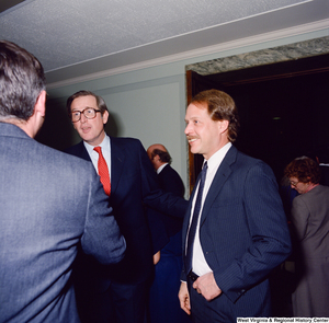 ["Senator John D. (Jay) Rockefeller and an unidentified individual pose for a photograph together following the Senate Swearing-In Ceremony."]%