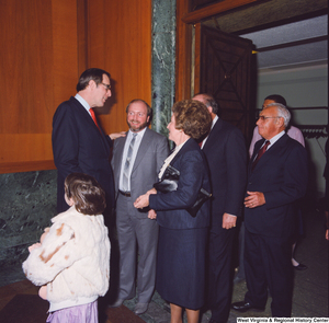 ["At the Senate Swearing-In Ceremony, Senator John D. (Jay) Rockefeller greets a group of unidentified individuals."]%