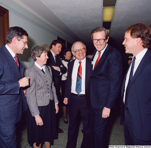 ["Senator John D. (Jay) Rockefeller and unidentified supporters chat following the Senate Swearing-In Ceremony."]%