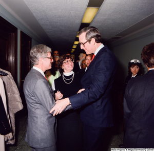 ["Senator John D. (Jay) Rockefeller shakes hands with an unidentified individual following the Senate Swearing-In Ceremony."]%