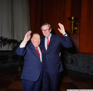 ["Senator John D. (Jay) Rockefeller and former senator Jennings Randolph raise a hand for a photo following the Senate Swearing-In Ceremony."]%