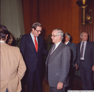 ["An unidentified supporter speaks with Senator John D. (Jay) Rockefeller after the Senate Swearing-In Ceremony."]%