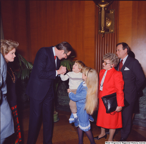 ["Senator John D. (Jay) Rockefeller greets a smiling young supporter following his Senate Swearing-In Ceremony."]%