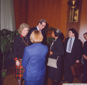 ["A group of unidentified supporters talk with Senator John D. (Jay) Rockefeller and his wife Sharon at the Senate Swearing-In Ceremony."]%