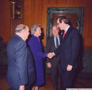 ["Former Senator Jennings Randolph and Senator John D. (Jay) Rockefeller speak with two unidentified supporters at the Senate Swearing-In Ceremony."]%