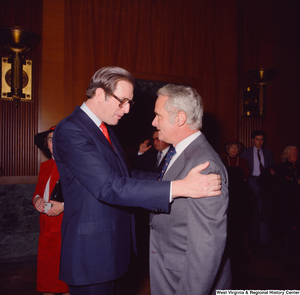 ["Senator John D. (Jay) Rockefeller embraces an unidentified supporter at the Senate Swearing-In Ceremony"]%