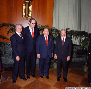 ["Senator John D. (Jay) Rockefeller, Senator Robert C. Byrd, and former Senator Jennings Randolph pose for a photograph with an unidentified individual at the Senate Swearing-In Ceremony."]%