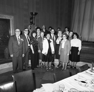 ["Unidentified members of the National Association of Postmasters of the United States gather for a photograph during an event at the Senate."]%