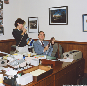 ["Senator John D. (Jay) Rockefeller props his legs up on a desk and speaks to an unidentified staff member in his Washington office."]%