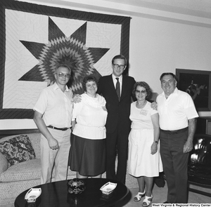 ["Senator john D. (Jay) Rockefeller stands for a photograph with four unidentified individuals in his Washington office."]%