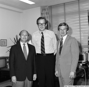 ["Senator John D. (Jay) Rockefeller stands for a photograph with two unidentified guests in his Washington office."]%