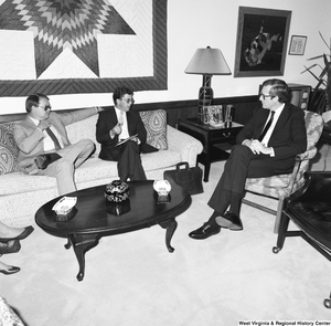 ["Senator John D. (Jay) Rockefeller sits and listens to two unidentified members from a West Virginia Regional Progress organization."]%