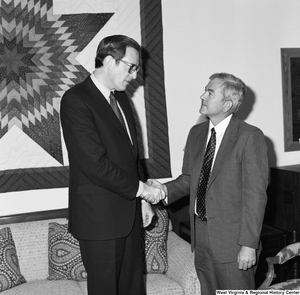 ["Senator John D. (Jay) Rockefeller shakes hands with an unidentified guest in his office."]%