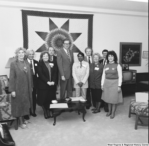 ["Senator John D. (Jay) Rockefeller stands for a photograph with an unidentified group in his Washington office."]%