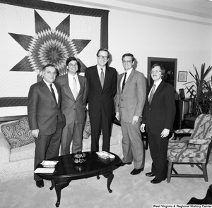 ["Senator John D. (Jay) Rockefeller poses for a photograph with a group of unidentified men in his Washington office."]%