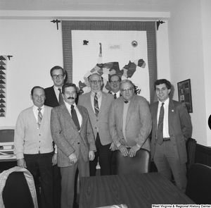 ["Senator John D. (Jay) Rockefeller stands for a photograph with a group of unidentified men in his Washington office."]%