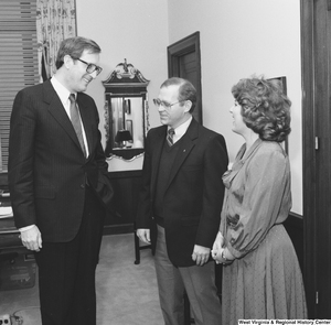 ["Senator John D. (Jay) Rockefeller laughs with the West Virginia \"Engineer of the Year\" and his wife."]%