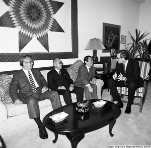 ["Senator john D. (Jay) Rockefeller sits in a chair and speaks with the president of Nisshin and two others in his Washington office."]%