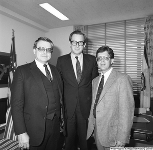 ["Senator John D. (Jay) Rockefeller stands for a photograph with two representatives from Marshall University in his Washington office."]%