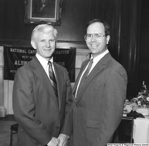 ["West Virginia University President Neil S. Bucklew stands for a photograph with an unidentified individual at an event hosted by the National Capitol Chapter of the West Virginia University Alumni Foundation."]%