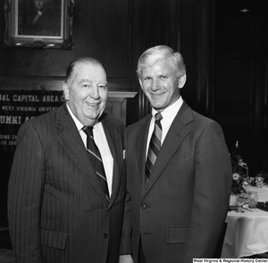 ["West Virginia University President Neil S. Bucklew and former West Virginia Senator Jennings Randolph stand for a photograph at a WVU Alumni Association event in Washington."]%