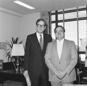 ["Senator John D. (Jay) Rockefeller stands for a photograph with an unidentified individual in his Washington office."]%