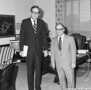 ["Senator John D. (Jay) Rockefeller stands with an engineering professor from West Virginia University in his Washington office."]%