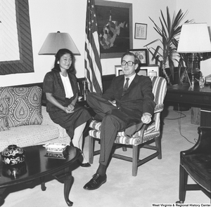 ["Senator John D. (Jay) Rockefeller sits on a chair in his office with one of his summer interns."]%