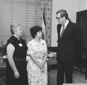 ["Senator John D. (Jay) Rockefeller speaks with two representatives from West Virginia Free in his Washington office."]%