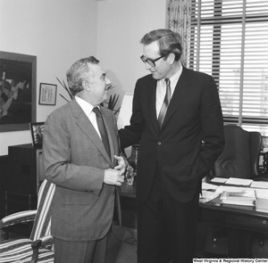 ["Senator John D. (Jay) Rockefeller speaks with an unidentified individual in his Senate office."]%