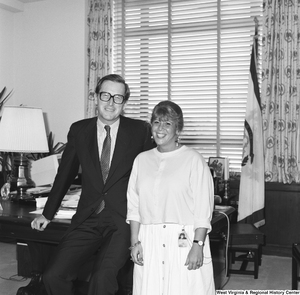 ["Senator John D. (Jay) Rockefeller poses for a photograph with an unidentified woman in his office."]%