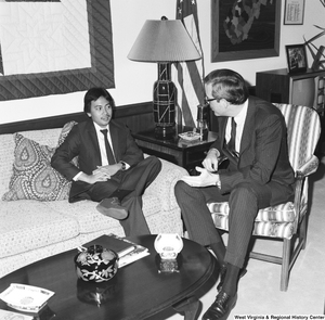 ["Senator John D. (Jay) Rockefeller sits on a chair in his office and speaks with an unidentified individual."]%