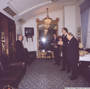 ["Senator John D. (Jay) Rockefeller, Senator Al Gore, and former Senator Jennings Randolph wait outside and greet Senator Robert C. Byrd as he exits a room."]%