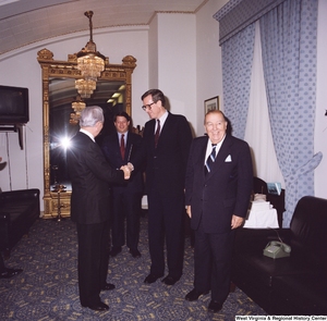 ["Senator John D. (Jay) Rockefeller shakes Senator Robert C. Byrd's hand at his birthday celebration."]%