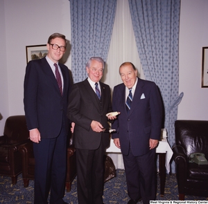 ["Senator Robert C. Byrd holds a piece of cake during his birthday celebration and stands for a photograph beside Senator John D. (Jay) Rockefeller and former Senator Jennings Randolph."]%