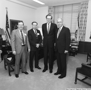 ["Senator John D. (Jay) Rockefeller stands with three representatives from the West Virginia Christian Schools Association in his office."]%