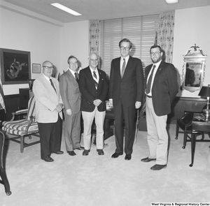 ["Senator John D. (Jay) Rockefeller stands with four representatives from Huntington Parks in his office."]%