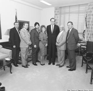 ["Senator John D. (Jay) Rockefeller stands with a group of six individuals from National Home Study in his office."]%