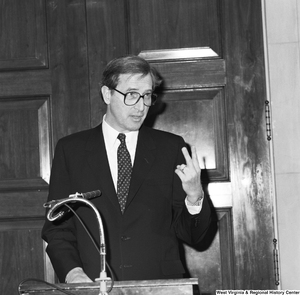 ["Senator John D. (Jay) Rockefeller speaks at an unknown event in Washington and holds up two fingers in this particular photograph."]%