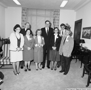 ["Senator John D. (Jay) Rockefeller stands among a group of representatives from West Virginia Extension Services."]%