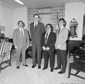 ["Senator John D. (Jay) Rockefeller stands among three unidentified men in his Washington office."]%