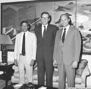 ["Senator John D. (Jay) Rockefeller stands between two unidentified men in his office."]%