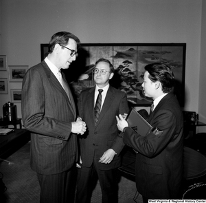 ["Senator John D. (Jay) Rockefeller speaks with a representative from China Steel and a representative from the Island Creek Coal Company."]%