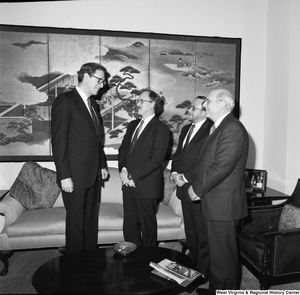 ["Senator John D. (Jay) Rockefeller speaks with representatives from University Health Associates and the Dean of the WVU School of Medicine."]%