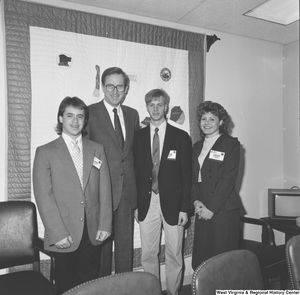 ["Senator John D. (Jay) Rockefeller stands with three students in his office."]%