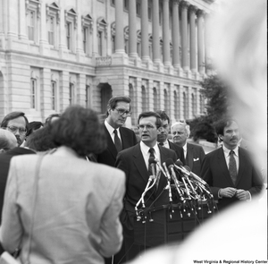 ["Senator John D. (Jay) Rockefeller standing outside the Senate while another man speaks."]%